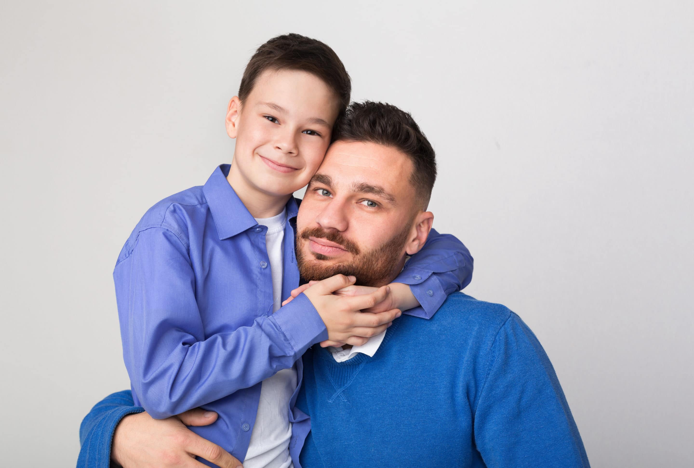 Happy family portrait. Cute boy embracing his father
